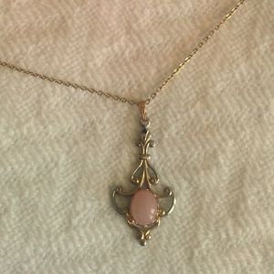 Gold-colored filigree necklace with rose gem
